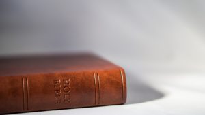 Holy Bible on side of table