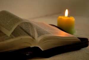 Bible with candle